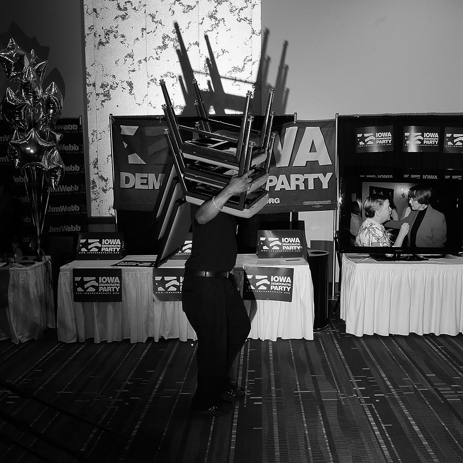 A staff member carries a stack of chairs at the 2015 Iowa Democratic Party Hall of Fame Celebration at the Cedar Rapids Convention Center in Cedar Rapids on Friday, July 17, 2015. (Adam Wesley/The Gazette)
