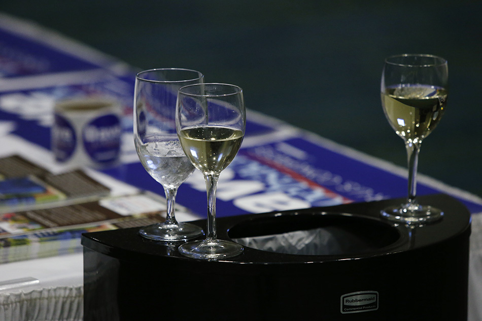 Half empty wine glasses sit atop a garbage can at the 2015 Iowa Democratic Party Hall of Fame Celebration at the Cedar Rapids Convention Center in Cedar Rapids on Friday, July 17, 2015. (Adam Wesley/The Gazette)