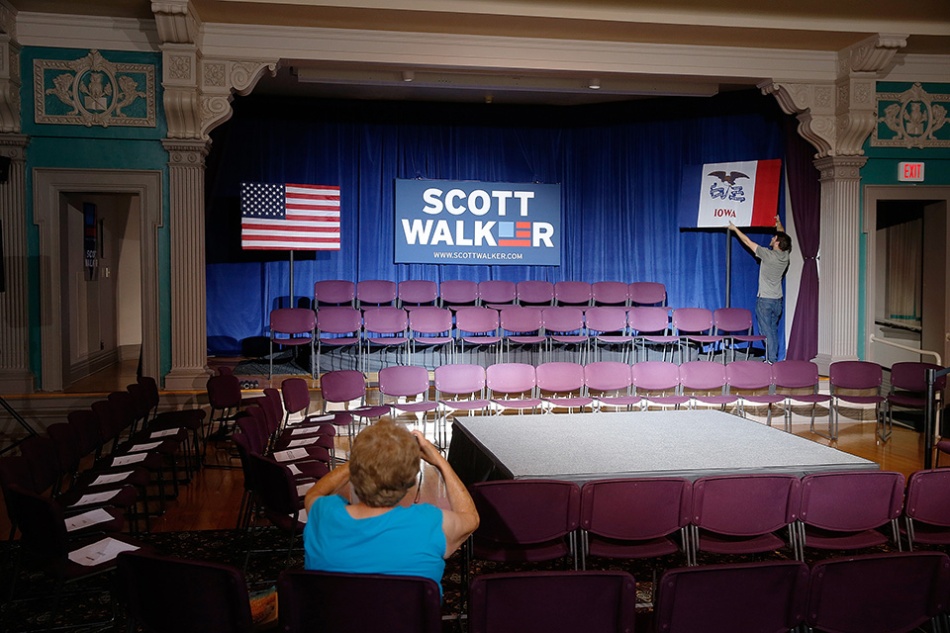 An early-arriving audience member takes a photo of the stage being set up for Wisconsin Gov. and Republican Presidential candidate Scott Walker's town hall event at the Cedar Rapids Museum of Art in Cedar Rapids on Friday, July 17, 2015. (Adam Wesley/The Gazette)