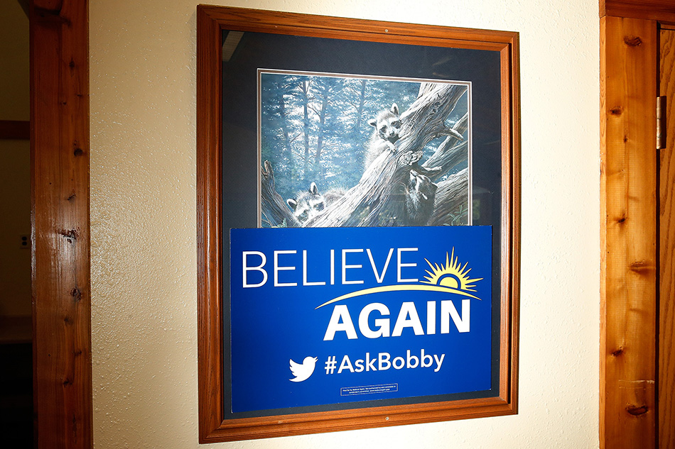 A sign for the "Believe Again" federal Super PAC supporting GOP presidential candidate Bobby Jindal is taped over artwork before a town hall event with Jindal at Prairie Oak Lodge in Marion on Monday, Aug. 10, 2015. (Adam Wesley/The Gazette)
