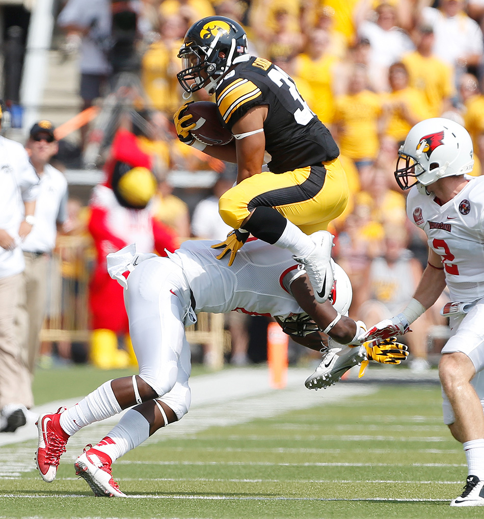 A rare moment of interest on the field, as Iowa Hawkeyes running back Jordan Canzeri (33) attempts to hurdleIllinois State Redbirds safety La'Darius Newbold (8) in a NCAA college football game at Kinnick Stadium in Iowa City on Saturday, Sept. 5, 2015. (Adam Wesley/The Gazette)