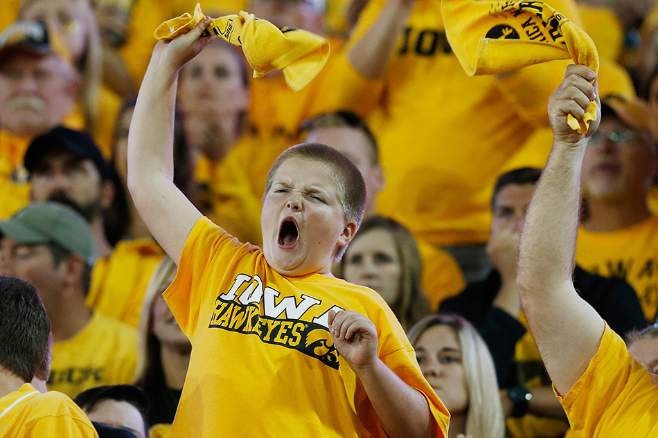 A young Iowa fan cheers in a NCAA football game against Pitt at Kinnick Stadium in Iowa City on Saturday, Sept. 19, 2015. (Adam Wesley/The Gazette)
