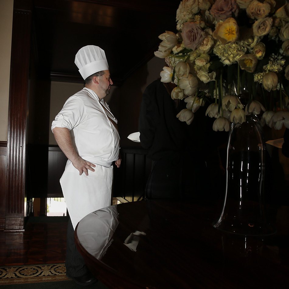 A chef speaks to early attendees to the Linn county Eagle's luncheon where Republican Presidential candidate Jeb Bush spoke at the Cedar Rapids Country Club in Cedar Rapids on Tuesday, Sept. 22, 2015. (Adam Wesley/The Gazette)