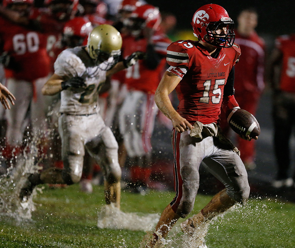 Iowa City High quarterback Nate Wieland (15) runs out of bounds against Iowa City West in a class 4A high school football game at City High School in Iowa City on Friday, Sept. 18, 2015. (Adam Wesley/The Gazette)