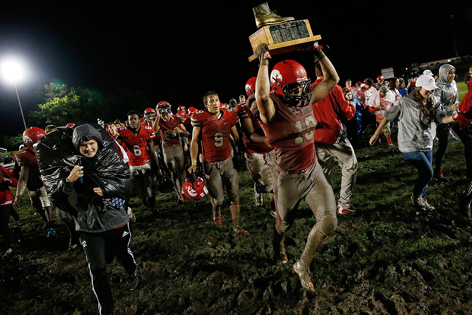 Iowa City High's Kyle Swenning (10) runs across the field with the boot after the Little Hawks defeated Iowa City West in a class 4A high school football game at City High School in Iowa City on Friday, Sept. 18, 2015. (Adam Wesley/The Gazette)