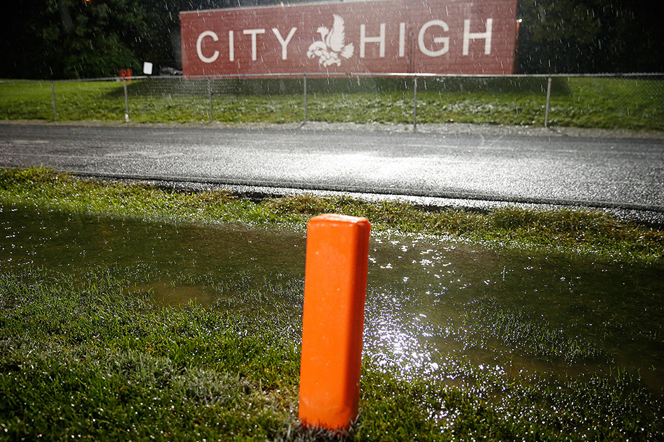 Standing water by the end zone at Iowa City High's football field is shown during a thunderstorm at City High School in Iowa City on Friday, Sept. 18, 2015. (Adam Wesley/The Gazette)