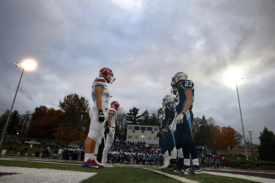 Captains from Cedar Rapids Jefferson and Dubuque Senior line up at midfield before a 1st round class 4A high school football playoff game at Ash Park Stadium at Cornell College in Mount Vernon on Wednesday, Oct. 28, 2015. (Adam Wesley/The Gazette)