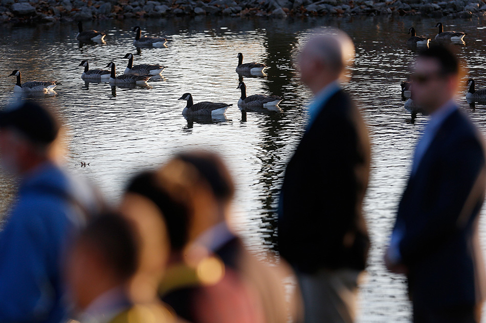 Geese swim on nearby pond as secret service officers patrol during an appearance by Democratic Presidential candidate Hillary Clinton at a town hall event at S.T. Morrison Park in Coralville on Tuesday, Nov. 3, 2015. (Adam Wesley/The Gazette)