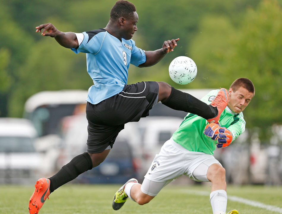 South Tama's Jerry Lowe (9) scores a goal past Bishop Heelan goalie Nathan Gobell (1) in a Class 2A quarterfinal at the Cownie Soccer Complex in Des Moines on Thursday, June 4, 2015. South Tama won 3-2. (Adam Wesley/The Gazette)