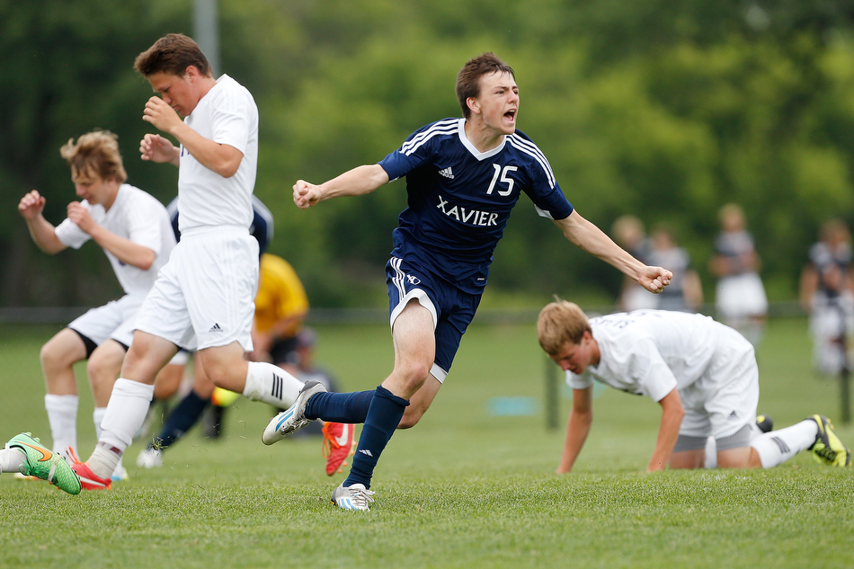Cedar Rapids Xavier's Luke Duball (15) celebrates after scoring a golden goal in the 2nd period of extra time to win the 2A championship match for the Saints over Central DeWitt at the Cownie Soccer Complex in Des Moines on Saturday, June 6, 2015. (Adam Wesley/The Gazette)
