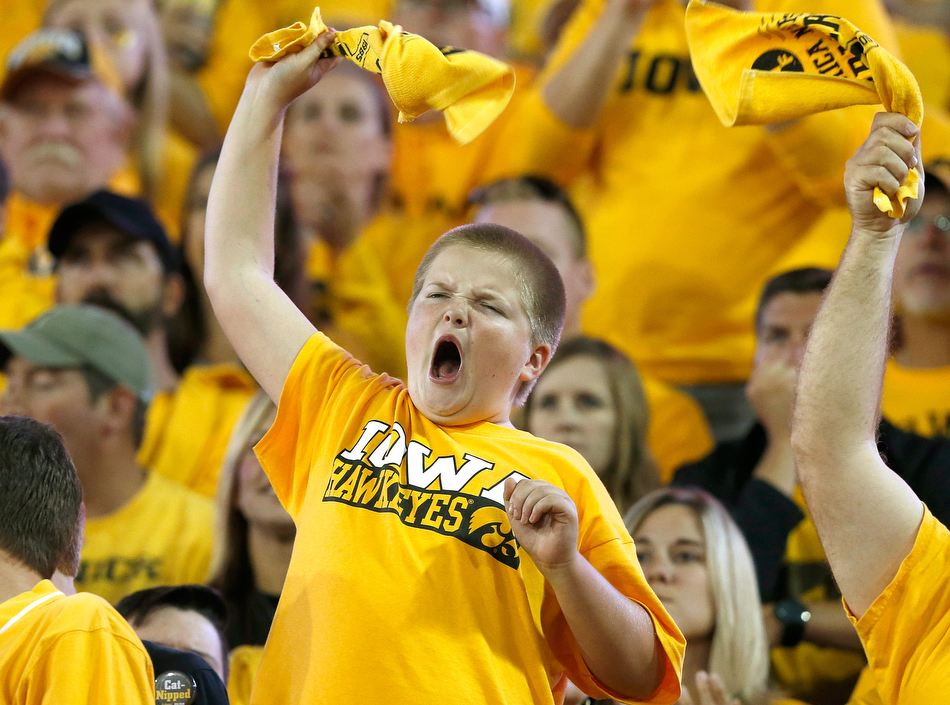 An Iowa fan cheers in a NCAA football game against Pitt at Kinnick Stadium in Iowa City on Saturday, Sept. 19, 2015. (Adam Wesley/The Gazette)