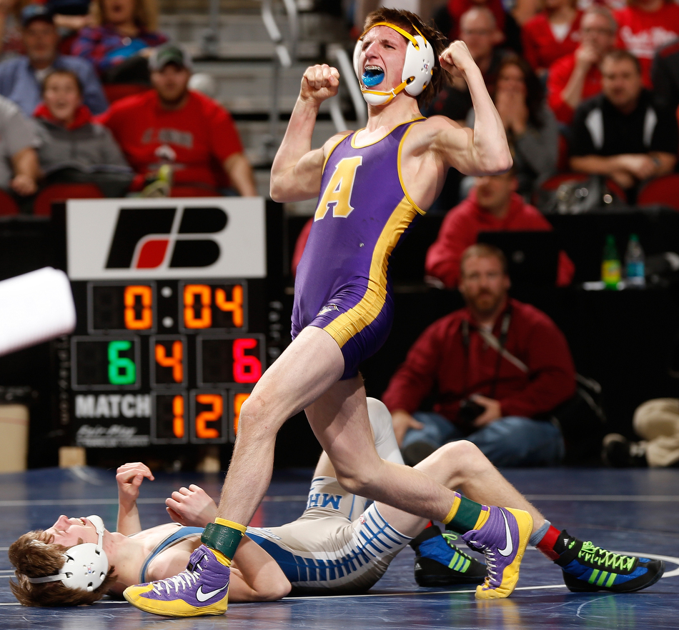 Alburnett's Drake Halblom flexes in celebration after pinning Moravia's Briar Cochran in sudden victory during a 120 pound first round 1A match at the 2015 State Wrestling tournament at Wells Fargo Arena in Des Moines on Thursday, Feb 19, 2015. (Adam Wesley/The Gazette)