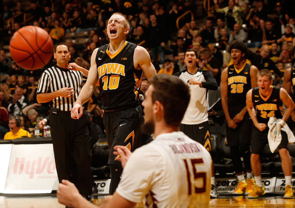 Iowa Hawkeyes guard Mike Gesell (10) reacts as Iowa Hawkeyes center Adam Woodbury (34) draws a foul in a NCAA basketball game against Florida State Seminoles at Carver-Hawkeye Arena in Iowa City on Wednesday, Dec. 2, 2015. (Adam Wesley/The Gazette)