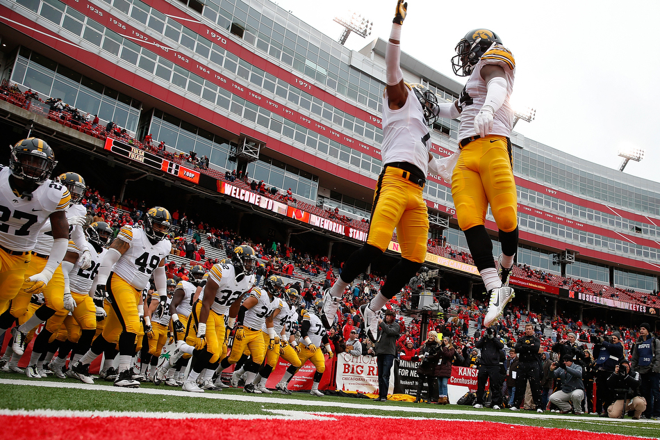 Iowa Hawkeyes defensive back Sean Draper (7) and Iowa Hawkeyes defensive back Desmond King (14) chest bump as the Hawkeyes take the field for warmups before a NCAA football game against Nebraska at Memorial Stadium in Lincoln on Friday, Nov. 27, 2015. (Adam Wesley/The Gazette)